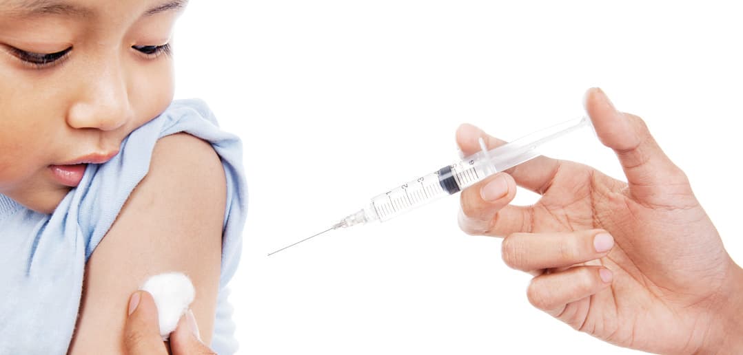 Pharmacist administering a private vaccine during a consultation